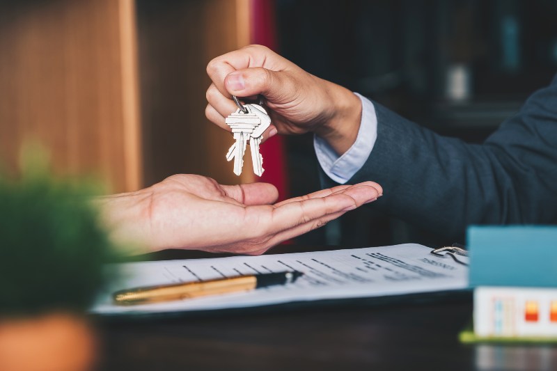 Person handing keys to someone to rent office from Urban Office
